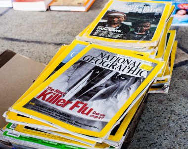 DELHI- MARCH 25, 2012: Collection of National Geographic Magazines on Mar. 25, 2012 in Daryaganj, Old Delhi Sunday market clipart