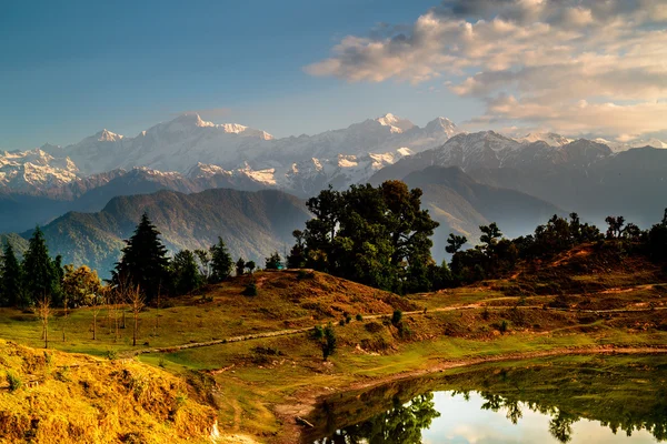 Deoria Tal Lake and Himalayas at sunrise Stock Picture
