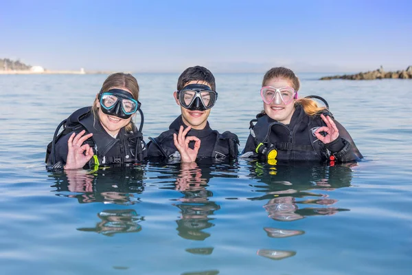 Smiling Scuba Divers Sea Facing Camera Dive Masks Showing Sign — Photo