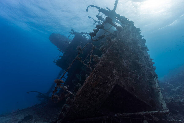 The bow of a large ship wreck underwater laying on its side