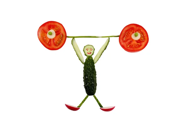 Healthy eating. Funny little man of the cucumber slices raises t — Stock Photo, Image