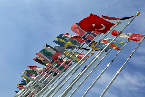 Different countries flags united together against blue sky — Stock Photo, Image