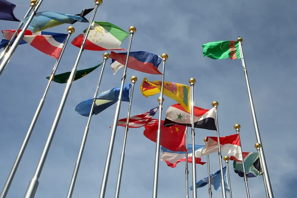 Different countries flags united together against blue sky — Stock Photo, Image