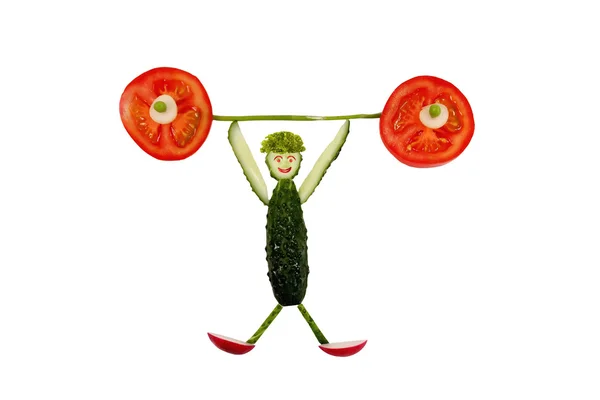 Healthy eating. Funny little man of the cucumber slices raises t — Stock Photo, Image