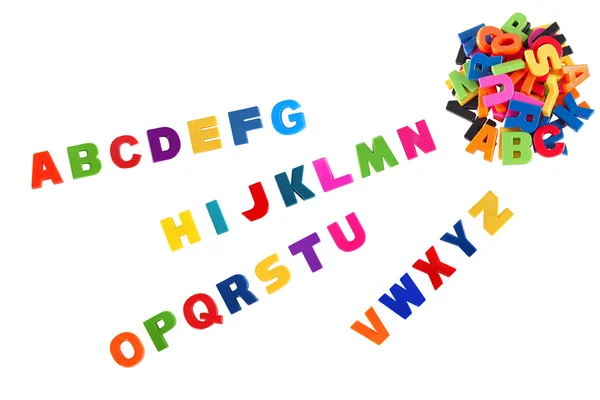 Alfabetet skrivet med flerfärgad plast barn bokstäver — Stockfoto