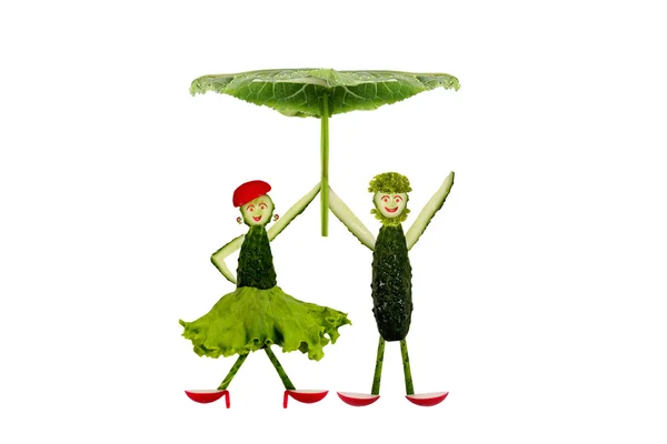 Funny little people made ??of cucumber under an umbrella — Stock Photo, Image