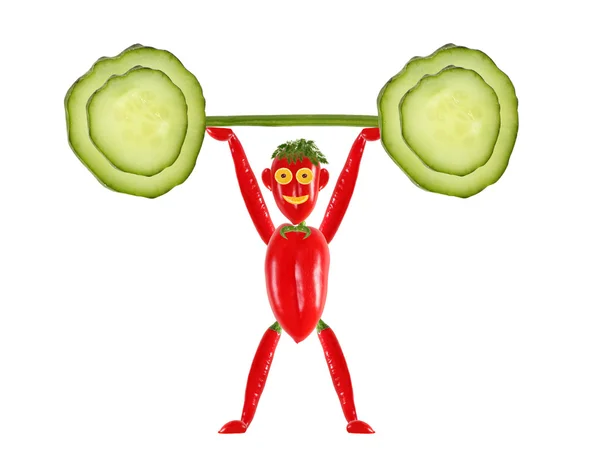 Comer saludable.Pequeño hombre divertido hecho de pimienta levanta la barra . — Foto de Stock