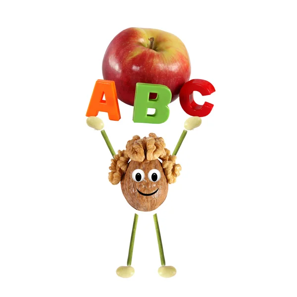 Healthy eating. Funny little man of the walnut lifting word - ABC with apple — Stock Photo, Image