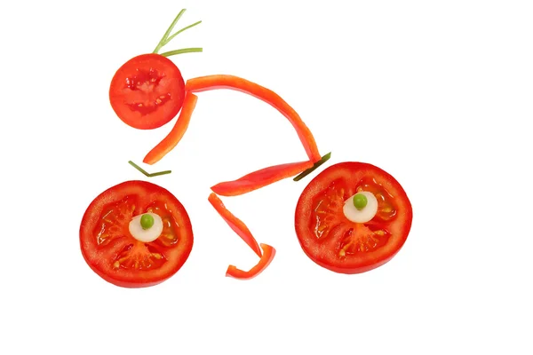 Healthy eating. Funny little man of the pepper slices on a bicyc — Stock Photo, Image