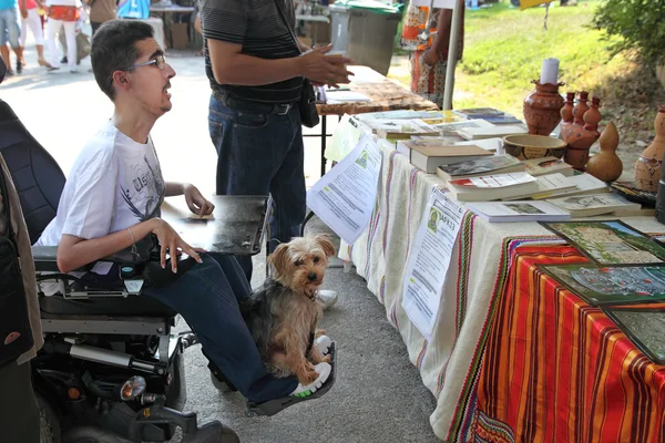 Foto de un joven en silla de ruedas con su mascota . — Foto de Stock