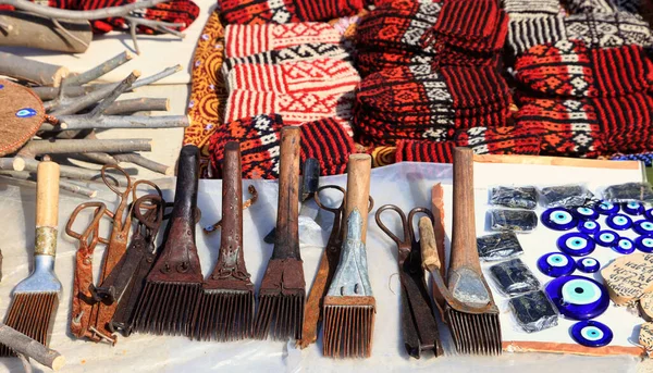 Knit slippers with traditional ornament and carpet making tools. Turkmenistan. Ashkhabad market.