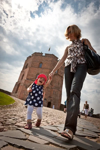 Mother and baby walking in old city — Stock Photo, Image
