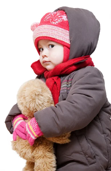 Bambino in abiti invernali su sfondo bianco Foto Stock