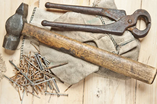 Vintage hammer with nails on wood background Stock Picture