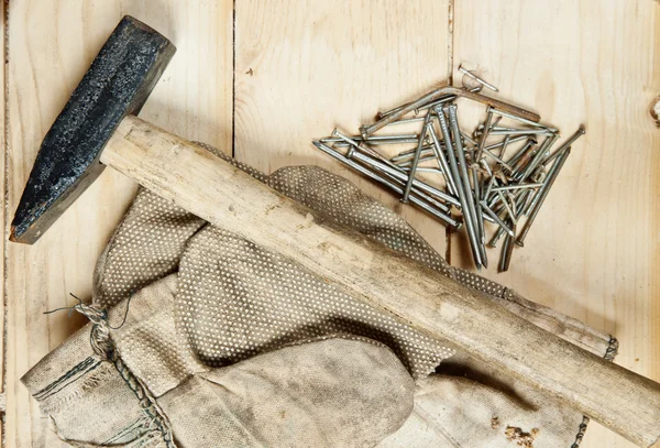 Vintage hammer with nails on wood background Royalty Free Stock Photos