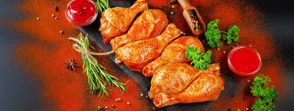 Convenience food, precooked.Raw Marinated chicken meat legs with spices for cooking for BBQ dark background. Top view. — Stock Photo, Image