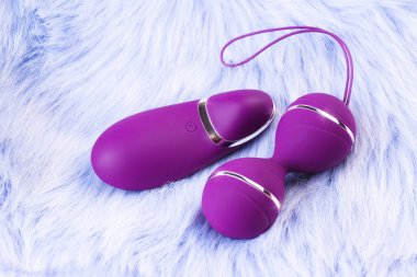 Pink vaginal balls,pink background.Double vaginal balls. Strengthening the intimate muscles of the vagina.dildo vibrator. Strengthening the intimate muscles of the vagina.