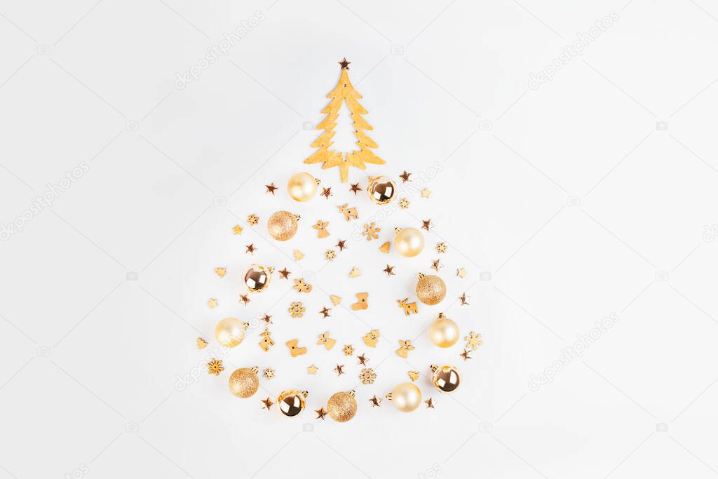 Simple minimalistic Christmas home decor of a wooden Christmas tree.Christmas, winter, new year concept.Decorative wooden Christmas tree on a light background with New Years decorations.