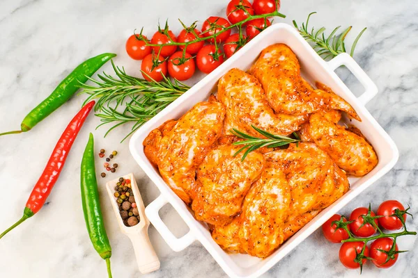 Chicken wings are raw in the marinade. Oven baking wings. Semifinished. Fast cooking.Raw Marinated chicken meat wings for BBQ,Cooking chicken with spices . Grilled chicken wings recipe.