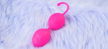 Pink vaginal balls,pink background.Double vaginal balls. Strengthening the intimate muscles of the vagina.dildo vibrator. Strengthening the intimate muscles of the vagina.