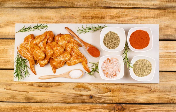 Chicken wings are raw in the marinade. Oven baking wings. Semifinished. Fast cooking.Raw Marinated chicken meat wings for BBQ,Cooking chicken with spices . Grilled chicken wings recipe.