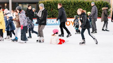 Slovakia.Bratislava.05.01.2020.Enjoying winter outdoor activities.Outdoor.Winter sport.People ice skating on the City Park Ice Rink in Europe.Group of teenage friends ice skating on an ice rink.