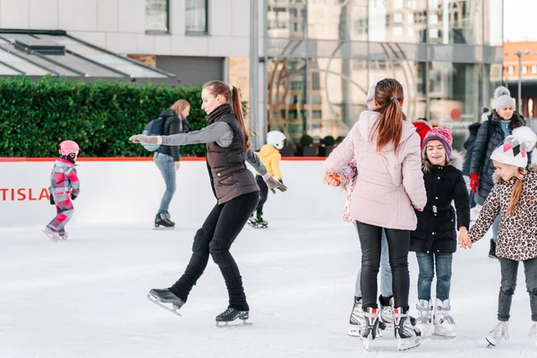 Slovakia.Bratislava.28.12.2018 .Focus morbido e selettivo.Gente che pattina sulla pista di pattinaggio City Park in Europa. Gruppo di amici adolescenti che pattinano su una pista di pattinaggio su ghiaccio. — Foto Stock