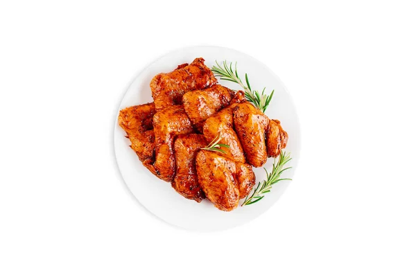 Marinated chicken wings in red sauce on isolated white background.Top view.Copy space.Semifinished. Fast cooking.Raw marinated chicken meat.