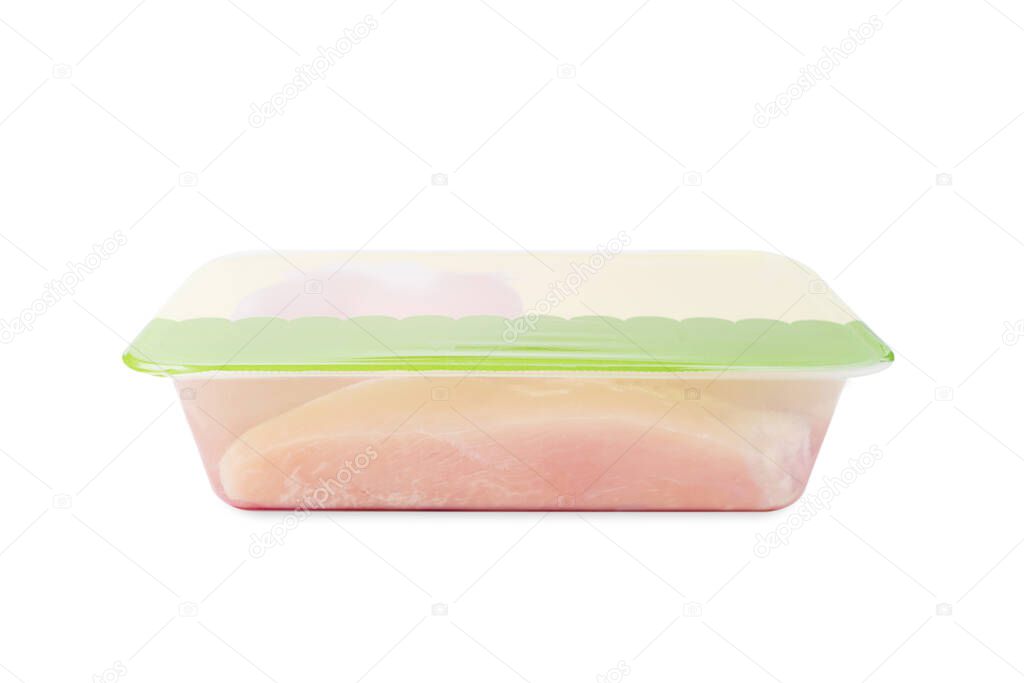 Side view.Raw Chicken meat in a tray for supermarket.Transparent tray with meat on an isolated background.Lots of fresh skinless chicken fillets in a plastic tray in a supermarket.