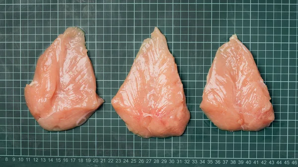 Fresh chicken fillet on line board. Raw chicken fillet meat without skin without bone, for cooking.