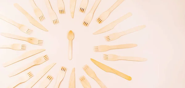 Disposable wooden cutlery.Eco concept.Banner eco friendly disposable kitchenware utensils on white background.Wooden forks,spoons,zero waste.Copy space.Eco friendly wooden cutlery.plastic free concept