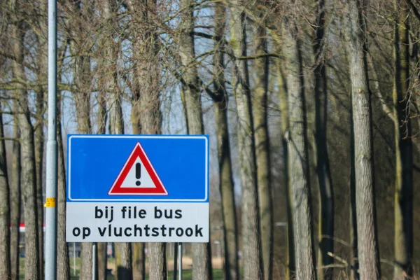 荷兰A12高速公路指示的蓝色方向和信息标志警告在繁忙时间紧急车道上的公共汽车 — 图库照片