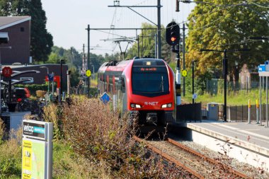 Two R-NET commuter trains are waiting on station of Boskoop between Gouda and Alphen aan den Rijn in the Netherlands