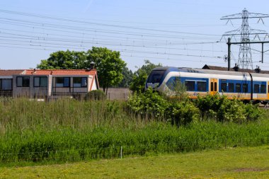 SLT sprinter local commuter train along the rail bridge at Kethel in schiedam in the Netherlands