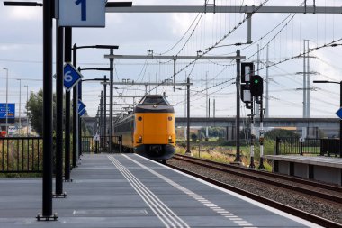 Koploper adlı ICM Intercity treni Hollanda 'daki Lansingerland Zoetermeer istasyonunda hızla ilerliyor.