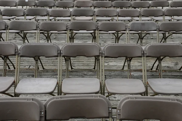 Brown plastic chairs aligned on a terrace — Stock Photo, Image