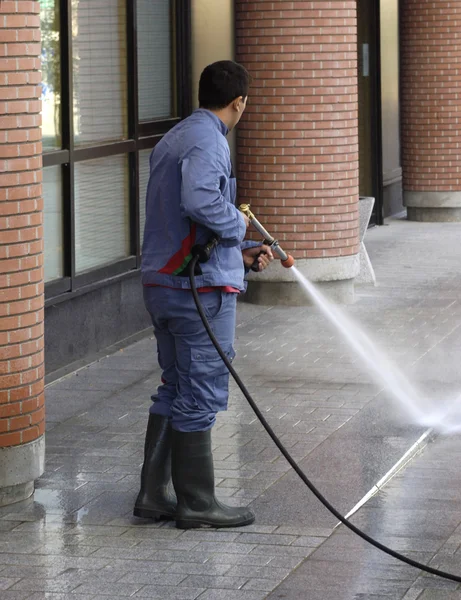 Ein Mann putzt mit einem Hochdruckreiniger — Stockfoto