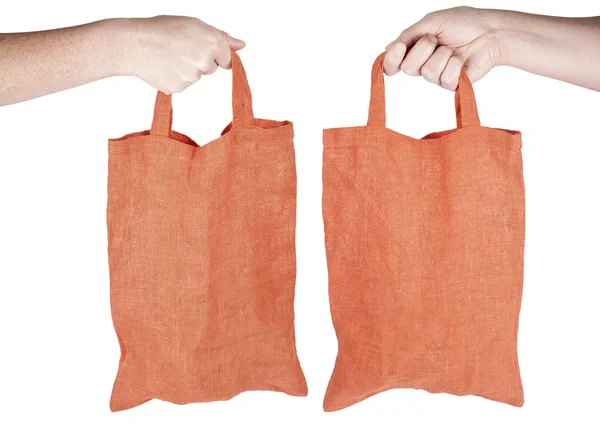 Mão segurando saco de compras reutilizável tecido laranja — Fotografia de Stock