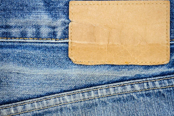 Label sewed on a blue jeans — Stock Photo, Image