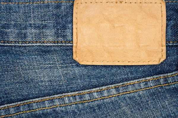 Label sewed on a blue jeans — Stock Photo, Image