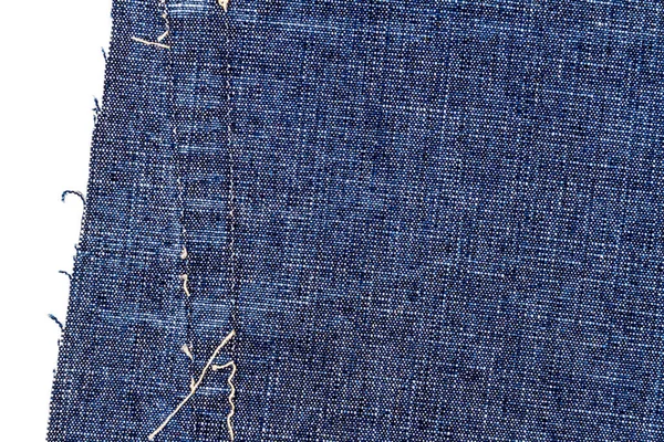 Piece of blue jeans fabric with a ripped of back pocket isolated on white background. Rough uneven edges. Denim fabric torn.