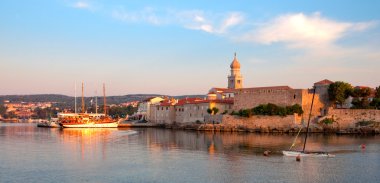 Panoramic view of Krk port and city walls from the sea - Croatia clipart