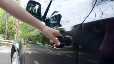 Kadının elini arabanın kapağını kapat. Kadın arabaya biner ve kapıyı kapatır. Kadın aracın içinde oturuyor. El kızı araba açar ve kuaförde oturur..