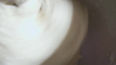 4K, un karıştırma makinesi kullanarak ekmek hamuru üretme işlemini kapat. Makine ekmek hamuru yoğurur. Ev yapımı çiğ ekmek ve küçük makine. Yiyecek konsepti.