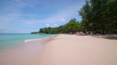 4K Beautiful tropical beach with blue sky and clouds. Tropical beach with waves crashing empty beach. Andaman Phuket beach Thailand. Sea sand and sky on beautiful summer day holiday vacation freedom