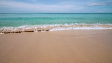 4K Beautiful tropical beach with blue sky and clouds. Tropical beach with waves crashing empty beach. Andaman Phuket beach Thailand. Sea sand and sky on beautiful summer day holiday vacation freedom