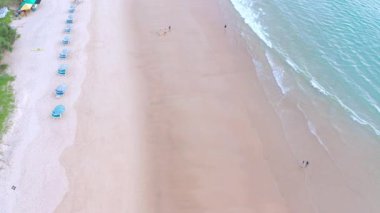 4K Aerial insansız hava aracı, Phuket, Tayland 'da günbatımı olan tropikal plajdaki insanların en iyi görüntüsü Andaman Denizi' nde ünlü bir turizm merkezidir. Sahilde oynayan mutlu insanlar.