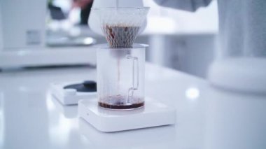 B roll shot Barista use hot pot process of brewing specialty coffee. Brewing coffee in a funnel. how to prepare a coffee filter. Work as a barista. Third wave coffee shop.