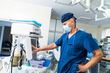 Professional surgery physician in face protective mask. Portrait of medical specialist in mask and uniform.