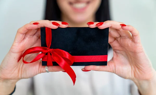 Gift card in woman hands. Business empty gift card holding in hands.